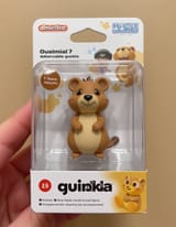 FLUX-00418-photo, [Australian brown color scheme round cheeks long tail small adorable quokka] as an amiibo figurine, inside packaging that reads %22[Quokka]%22 in large letters