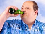 obese-man-drinking-beer-against-sky