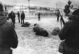 Members of the National Guard watch inmates wrapped in blankets following the riot at the Penitentiary of New Mexico oustide Santa Fe in 1980.