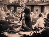 the-birth-of-a-nation-black-man-with-foot-on-desk-while-another-eats-chicken
