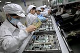 women assembling motherboards