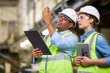 male engineer guiding the woman engineer