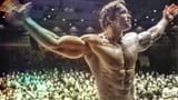 Arnold Schwarzenegger posing in the Mr. Olympia competition (1974) color