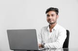 young-indian-man-working-office_75648-290