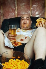 photo-fat-couch-potato-eating-600nw-76067524