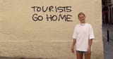 0_pay-locals-enraged-as-sarcastic-holidaymaker-poses-next-to-tourists-go-home-signs