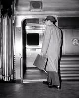 1950s-back-view-of-a-man-businessman-carrying-leather-briefcase-wearing-top-coat-and-hat-commuter-panoramic-images