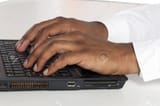 17258715-business-hands-typing-in-laptop-keyboard-on-a-macro-image