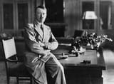 nazi-leader-adolf-hitler-sitting-on-the-edge-of-a-desk-at-his-berghof-residence-berchtesgaden