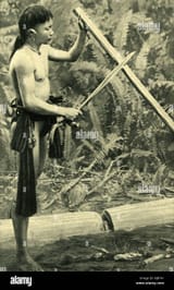 young-kayan-man-making-a-blowpipe-borneo-se-asia-RJB741