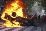 a-protester-burns-a-police-car-during-a-K5GZA4LFRRF5JETOCJ3BR4NIHA