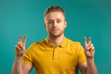 handsome-man-showing-hands-two-600nw-1945794478