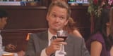 barney-toasting-a-drink-with-a-smirk-in-how-i-met-your-mother