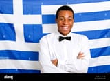 portrait-of-happy-man-with-arms-crossed-against-greek-flag-DP9CJK