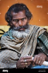 bearded-man-in-stare-with-scroll-varanasi-benares-india-ACWBRG