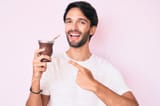 handsome-hispanic-man-drinking-mate-infusion-smiling-happy-pointing-hand-finger-handsome-hispanic-man-drinking-mate-226888400