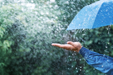 hand-blue-umbrella-under-heavy-rain-against-nature-background-rainy-weather-concept-hand-blue-umbrella-under-heavy-rain