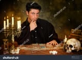 stock-photo-halloween-scene-of-a-young-astrologist-reading-tarot-cards-36487492