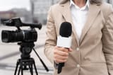 front-view-journalist-holding-microphone_23-2149032377
