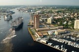 US_Navy_030820-N-9851B-011_Tug_boats_guide_USS_Harry_S._Truman_(CVN_75)_up_the_Elizabeth_River,_past_Portsmouth_landmarks