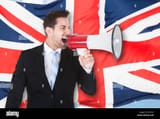 portrait-of-a-businessman-shouting-through-megaphone-in-front-of-british-KFGY33