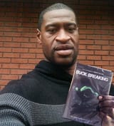 George_Floyd_holding_a_copy_of_Buck_Breaking