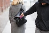 person-stealing-purse-from-handbag