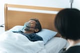 woman-watches-over-terminally-ill-600nw-2342236345