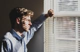 man-looking-out-of-window