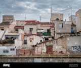 some-of-the-ramshackle-buildings-that-line-the-riverbank-in-orihuela-alicante-spain-2WKD5GM