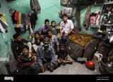 07122011-india-maharashtra-mumbai-members-of-a-family-pose-for-a-photo-in-their-cramped-and-modest-dwelling-in-mumbais-dharavi-slum-located-i-2K59AAG