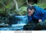 man-drinking-water-stream-260nw-1013466631