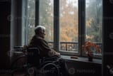 an-old-man-in-a-wheelchair-looks-out-the-window-from-his-home-into-the-autumn-generative-ai-photo