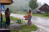Nude-girl-buys-the-honey-in-the-rain-3
