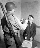 American_John_Simms_of_Pittsburg_PA_and_Louis_Lehaut_of_Cherbourg_France_toast_to_the_liberation_of_Paris_August_25_1944