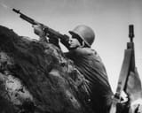 Lt_Gen_Robert_L_Eichelberger_fires_M1928_Thompson_submachine_gun_at_Japanese_positions_Battle_of_Buna-Gona_New_Guinea_1942