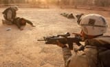 U.S. Army 3rd Division 3-7 Task Force soldiers take a surrendering Iraqi Captain and soldier into custody April 2, 2003 at a captured Iraqi army outpost in the outskirts of Baghdad