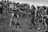 Brazilian_mine_laborers_confront_a_policeman_1986_policeman_is_carrying_Mauser_Mosquefal_M968
