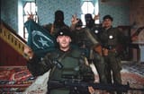Serb soldiers with captured Bosnian flag
