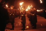 1280px-DF-ST-88-08721_Members_of_the_German_military_carry_lit_torches_in_honor_of_General_(GEN)_Charles_L._Donnelly_Jr._1987