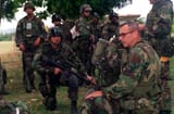 mg-meade-sits-under-the-trees-with-soldiers-dressed-in-combat-gear-and-m-16a1-1b7752-1024