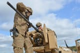 Soldiers assigned to Company D, 2nd Battalion, 7th Infantry Regiment, 1st Armored Brigade Combat Team, 3rd Infantry Division, install a weapon on a M1A2 Abrams Main Battle Tank
