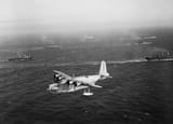 A_Short_Sunderland_Mk_I_flying_boat_of_No._210_Squadron_RAF_based_at_Oban_in_Scotland,_patrols_over_a_Canadian_troop_convoy_on_its_way_to_Greenock,_31_July_1940._CH832