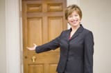 lady-gesturing-to-door-3907486434