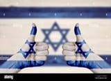 israel-flag-painted-on-female-hands-thumbs-up-with-blurry-wooden-background-FRRE6G