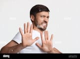 disgusted-man-frowning-gesturing-stop-over-white-background-2J49W3G-824624970
