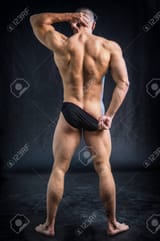 95239241-muscular-man-pulling-down-underwear-to-show-his-butt-in-studio-shot