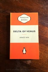 Delta-Of-Venus-Anais-Nin-Book-Laid-on-Wooden-Table-Keeping-Up-With-The-Penguins