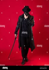 a-mysterious-ninja-assassin-in-a-noir-style-a-man-in-black-leather-clothes-with-a-coat-and-hat-covers-his-face-with-a-mask-and-uses-a-katana-photo-2GYM659