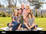 happy-family-with-three-generations-together-in-the-summer-in-the-garden-W4D13H